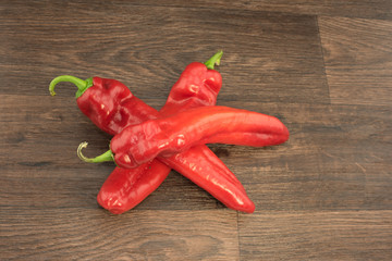 Delicious red hot chili peppers on a wooden table