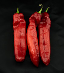 Fresh sweet red hot peppers paprika isolated on black