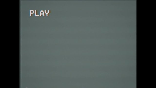 An old damaged VHS tape playing, gray screen with PLAY text. A vintage background for videos, a retro element.

