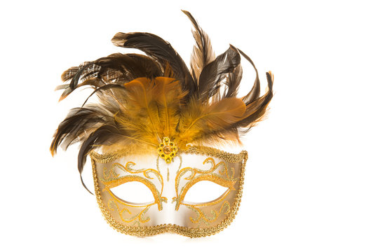 Pretty venetian golden carnival mask with feathers isolated on a white background