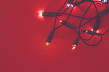 Fototapeta na wymiar Christmas lights on a red background