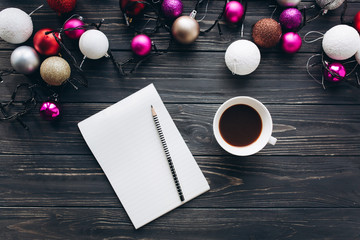 Christmas decorations, gifts and food on a wooden background.Drinking coffee and writing to do list on vintage notebook.