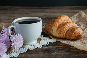 Breakfast. Coffee and croissants. Dark wood background. Horizont