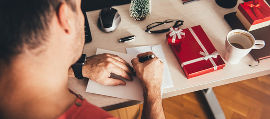 Man writing greeting card
