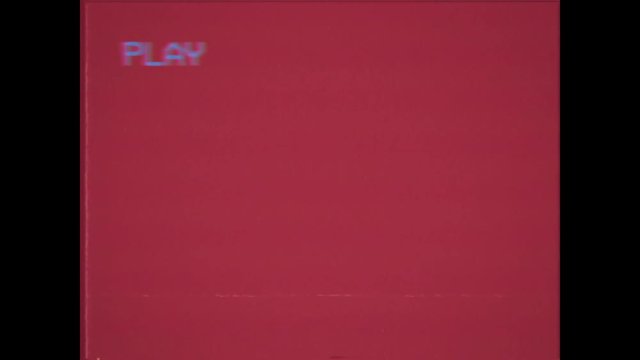 An old damaged VHS tape playing, red screen with PLAY text. A vintage background for videos, a retro element.
