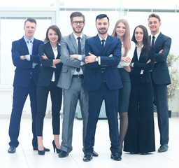 Fototapeta premium Smiling and confident business team standing in front of a bright window