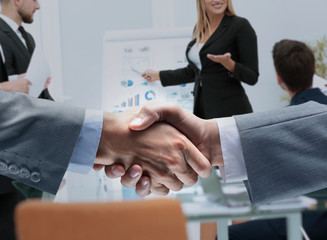 businessmen shaking hands after signing a lucrative financial co