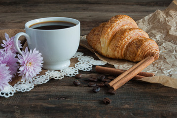 Breakfast. Coffee and croissants. Dark wood background. Horizont