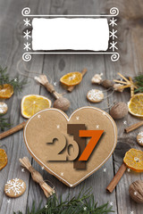 Fototapeta na wymiar 2017 Christmas heart shaped gingerbread background. Winter holidays atmosphere. Snoflakes. Hand drawn ribbon for copy.Perfect for greeting cards, flyers, etc.