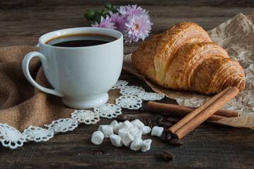 Breakfast. Coffee and croissants. Dark wood background. Horizont