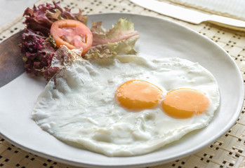 Two fried eggs in a plate for healthy breakfast