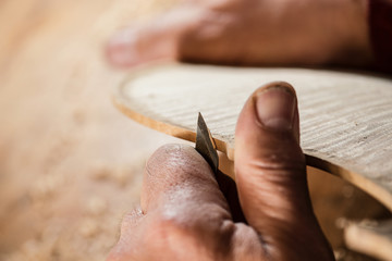 lute maker carving violin body
