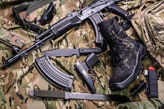 Army boot and different weapon/Military boot, gun, knife, rifle, pistol and machete.Top view