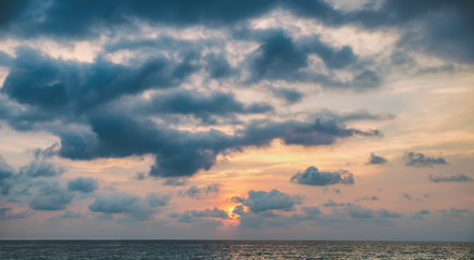 Obraz premium Cloudscape twilight heaven. Enigmatic nightly clouds over the water. Amazing sunset form beach in Thailand. Nature composition.
