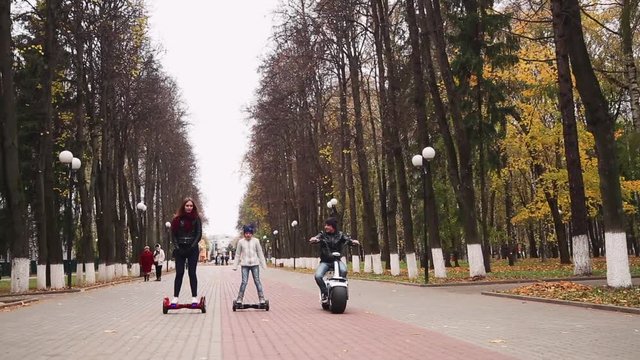 young people ride on gyroscooter and electric bike