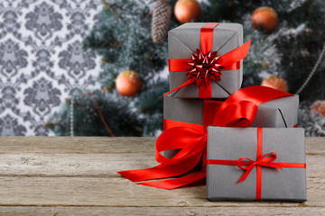 Christmas present on decorated tree background, holiday concept