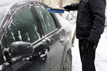 Clearing car of snow.