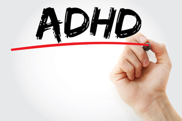 Hand writing ADHD with marker, concept background