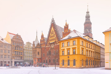 City hall and colorful houses on Market Square in the winter sunny morning in Wroclaw, Poland