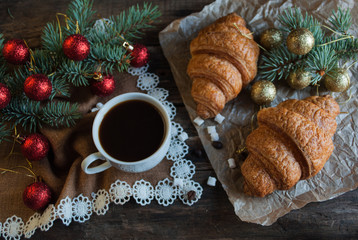 Christmas Breakfast. Coffee and Croissants. Dark Wood Background