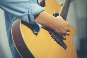 Young woman playing a guitar