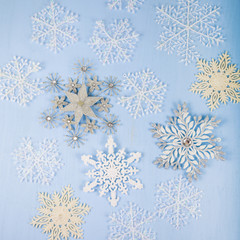 Silver decorative snowflakes on a blue wooden background. Christ