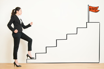 Side view of businesswoman climbing the stairs of drawing