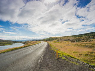 Empty road with a blue cloudy sky, Iceland