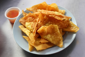 Deep Fried Wonton on white dish with plum sauce