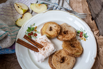 Apple slices in pastry with cinnamon and cream cheese on a wooden background. Perfect for the dessert diet or just a healthy meal.  Love for a healthy raw food concept.