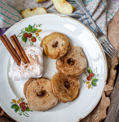 Apple slices in pastry with cinnamon and cream cheese on a wooden background. Perfect for the dessert diet or just a healthy meal.  Love for a healthy raw food concept.
