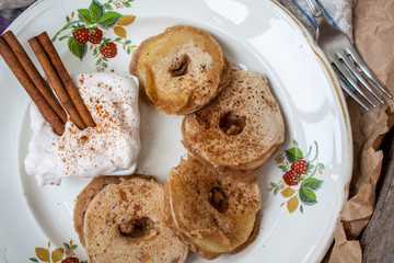 Apple slices in pastry with cinnamon and cream cheese on a wooden background. Perfect for the dessert diet or just a healthy meal.  Love for a healthy raw food concept.