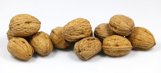 Walnut and a cracked walnut on the white background