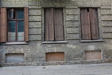 Fototapeta na wymiar Old European building decay with shutters
