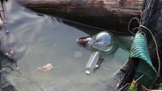 Garbage incandescent lamp in river