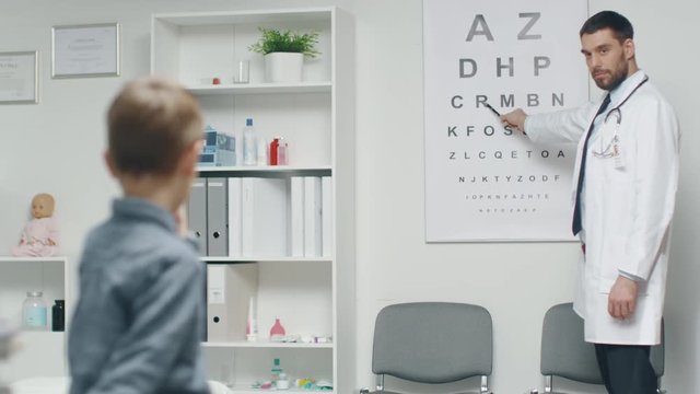 Young Boy is Checking His Eyesight in a Doctor's Office. room on a Doctor. Shot on RED Cinema Camera in 4K (UHD).