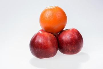 Orange and apple on a white background