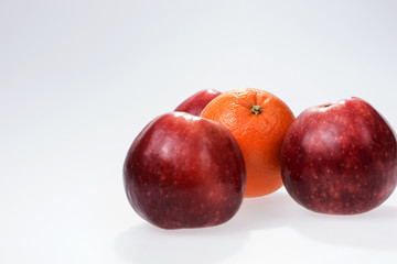 Orange and apple on a white background