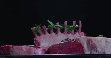 Still life raw meat composition rotation 4k looped video. Fresh cut meat parts pieces close-up. Beef retail advertising