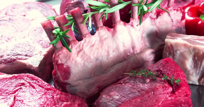Still life raw meat composition rotation looped video. Fresh cut meat parts pieces close-up. Beef retail advertising