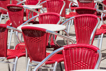 Close up from many modern red metal chairs and tables outdoor in restaurant in venedig