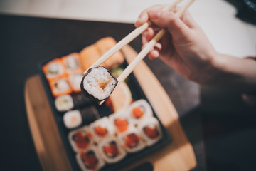 Set sushi set. Hand with chopsticks for sushi.
