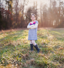 Beautiful young girl standing in a field