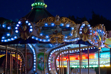 Carousel in amusement park at twilight