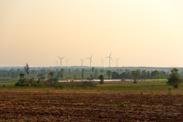 Fototapeta na wymiar Group of wind turbines over the field.
