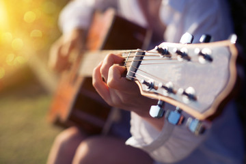 Fototapeta premium Female hand playing guitar outdoor