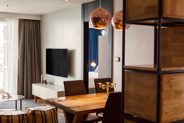 Furniture in living room interior design, lamps, TV screen on the wall, big window, wooden table and shelves