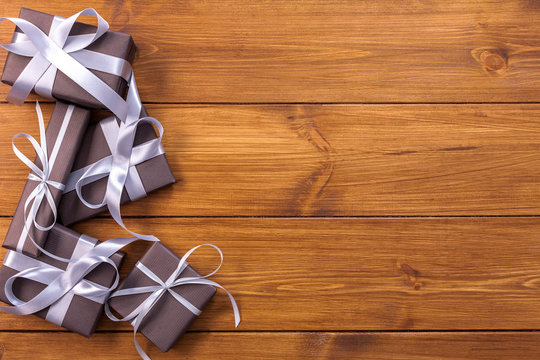 Presents in gift boxes on wood background with copy space