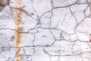 old plaster wall with stains from water and cracks