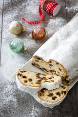 Christmas stollen. Traditional German Christmas dessert on wooden background
